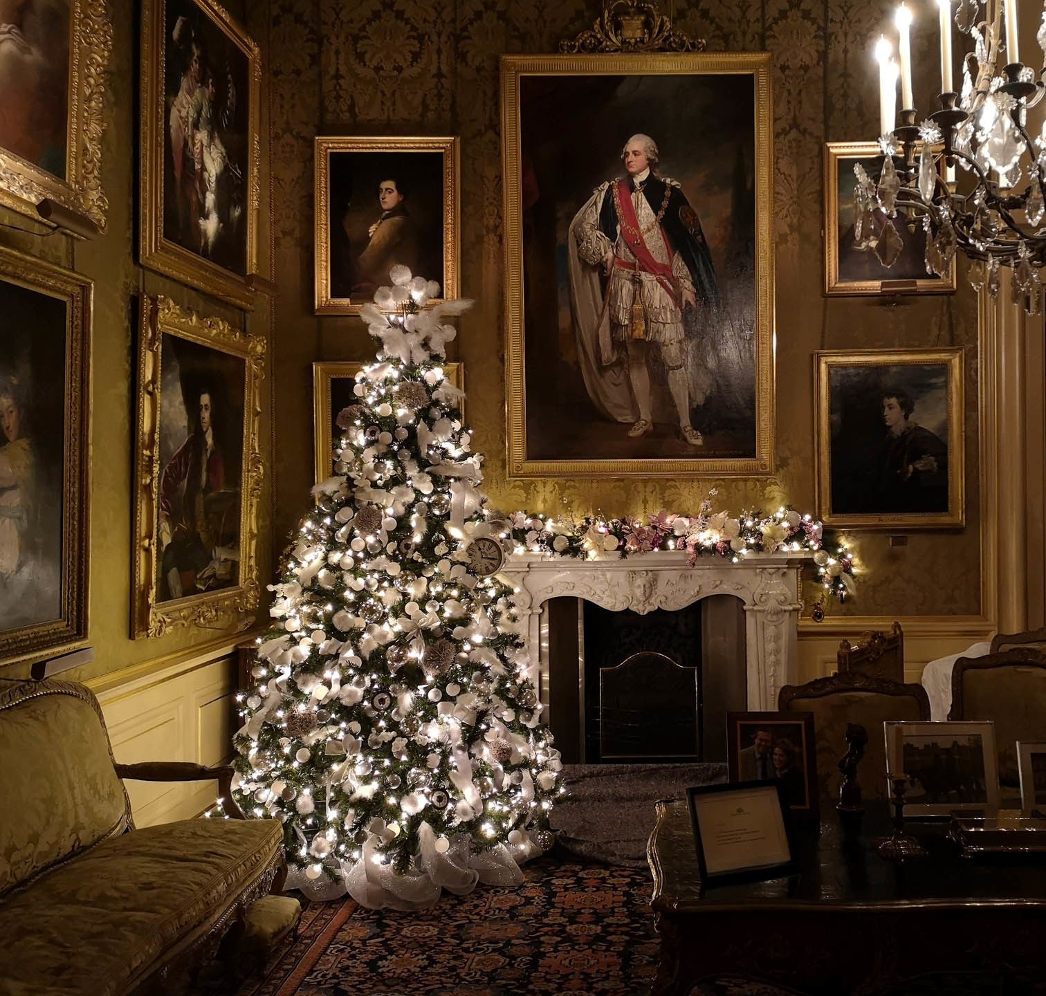Flocked Christmas tree in a period drawing room hung with portraits