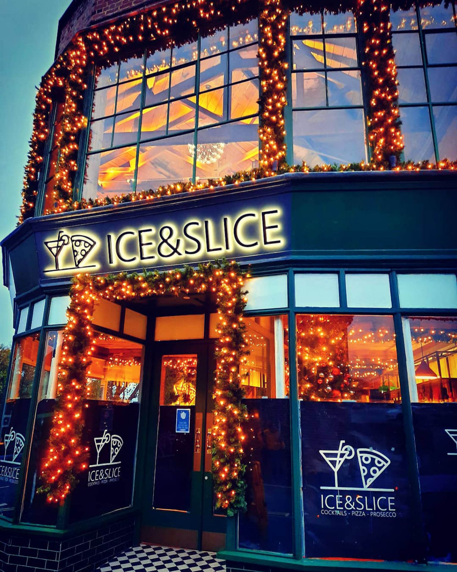 Ice & Slice restaurant frontage dressed with warm white Christmas lighting