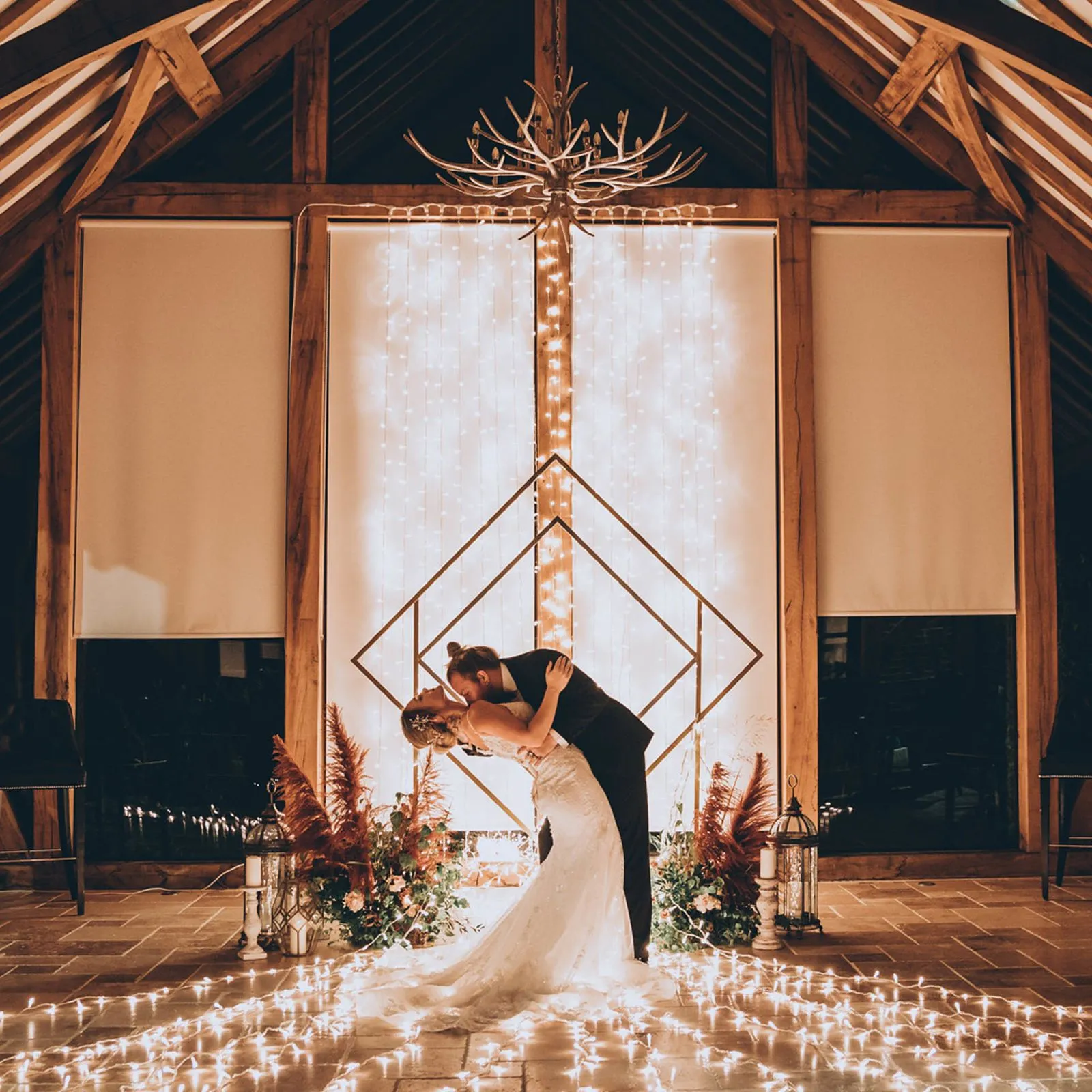 Bride and groom at a candlelit barn wedding ceremony