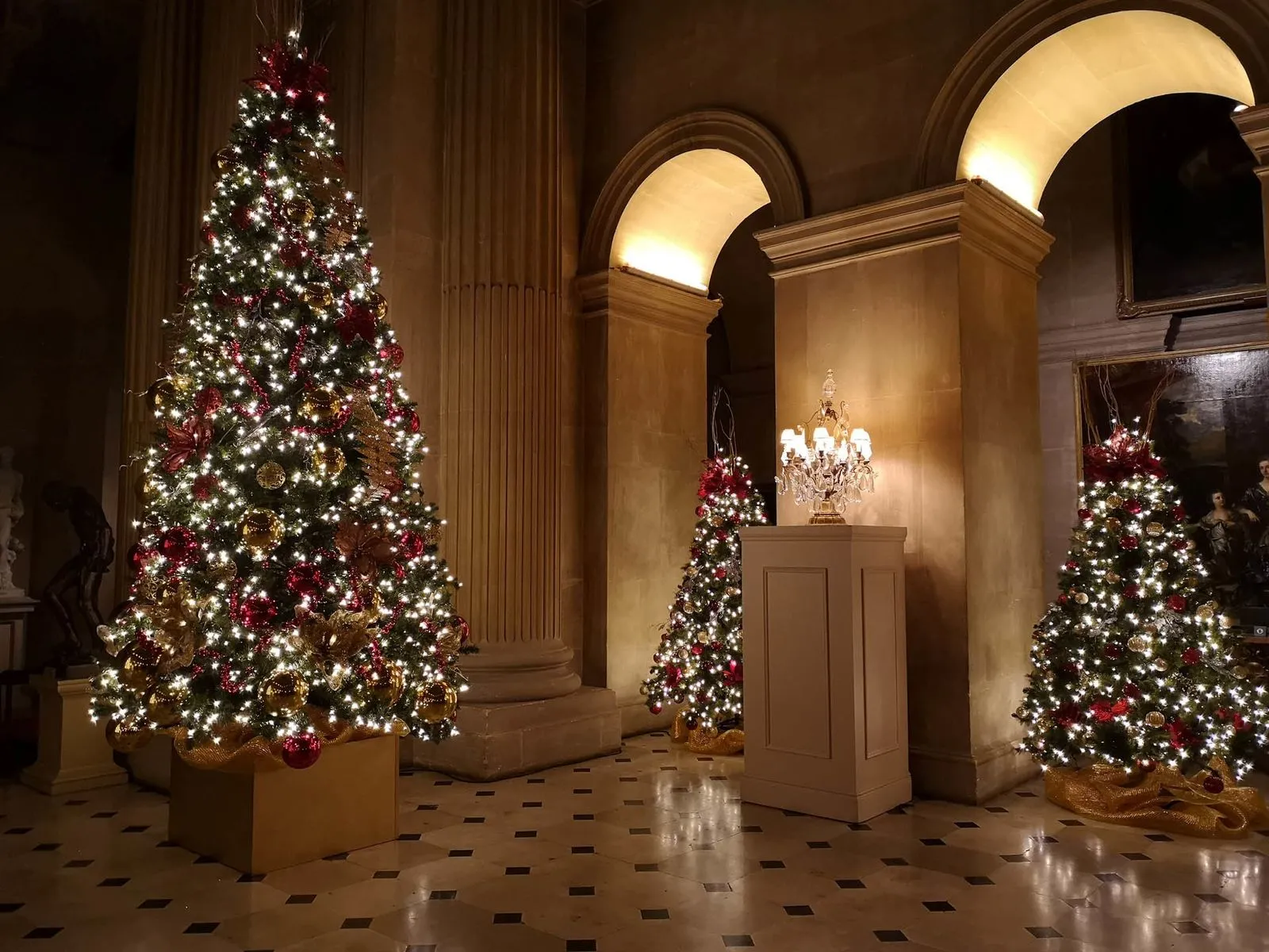 Christmas trees in a grand marble hall