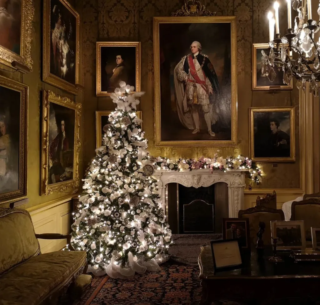 Flocked Christmas tree in a period drawing room hung with portraits